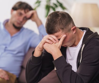 Frustrated,,Young,Man,Is,Sitting,At,Home,On,Couch.,Difficult