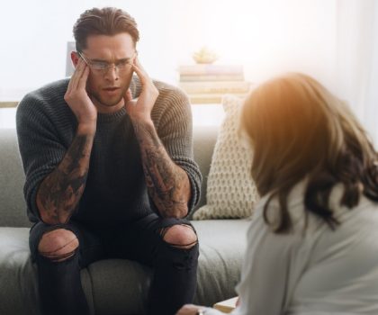 Therapy,,Psychologist,And,Man,With,Stress,On,Sofa,For,Mental